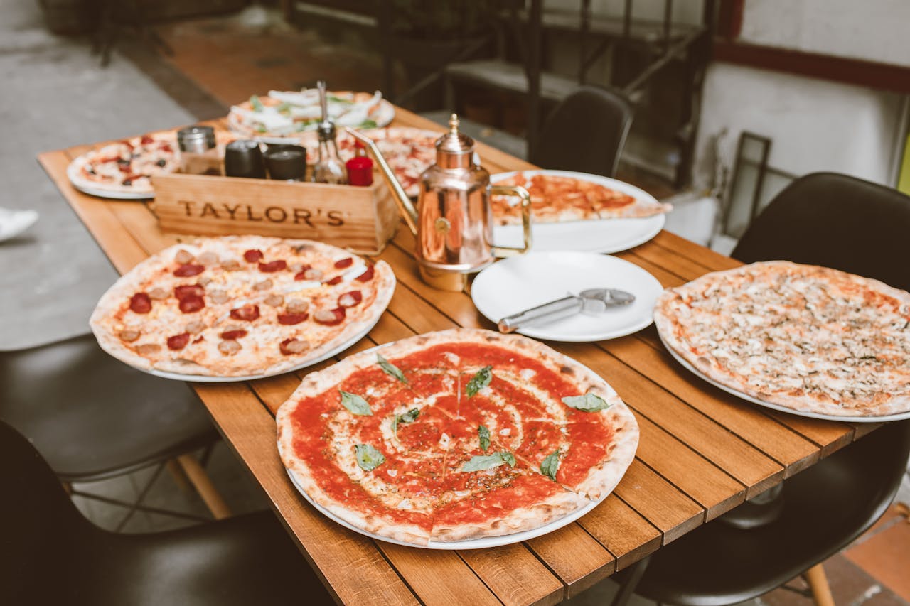 High Angle Shot of Pizzas on White Ceramic Plate